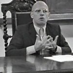 michel foucault sat at a desk