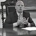 michel foucault sat at a desk