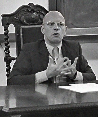 michel foucault sat at a desk