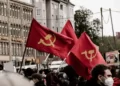 hammer and sickle flags flying at a communist rally