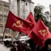 hammer and sickle flags flying at a communist rally
