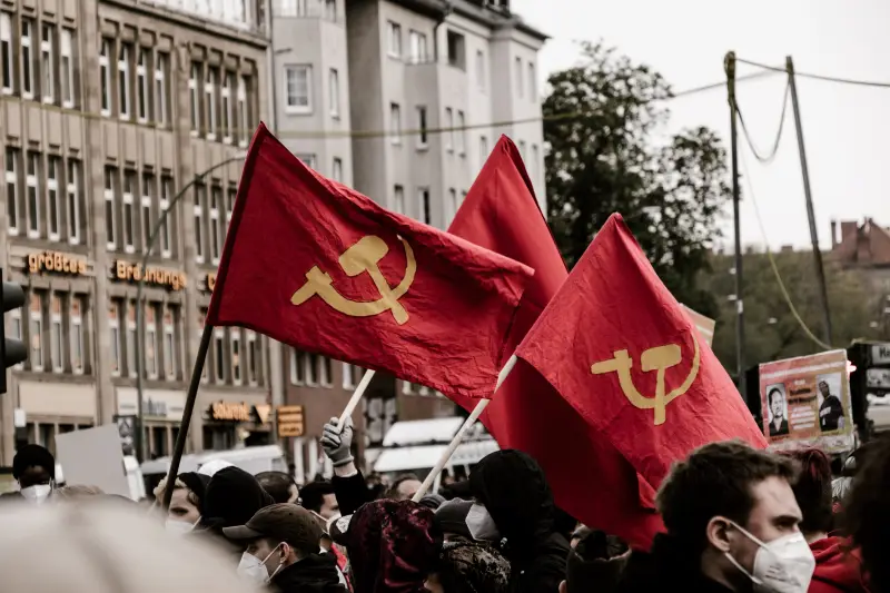 hammer and sickle flags flying at a communist rally