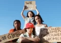 4 grils holding feminist signs