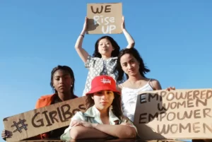 4 grils holding feminist signs