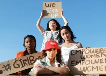 4 grils holding feminist signs