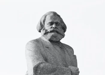 a statue of karl marx on a white background