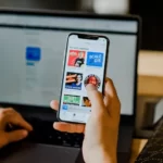 somebody holding a phone with social media apps