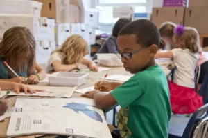 children sat around a table in primary school