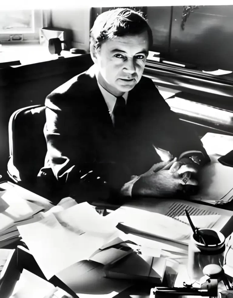 Black and white image of Erving Goffman sat at his desk