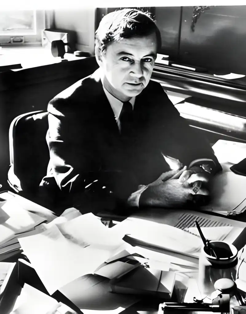 Black and white image of Erving Goffman sat at his desk