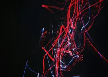 An abstract lined image in red and white on black background