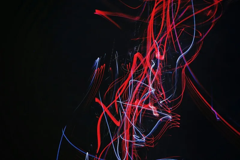 An abstract lined image in red and white on black background