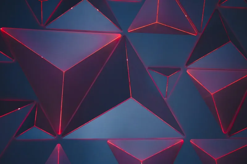 An abstract pattern of triangles in grey, purple and red hues