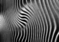 an abstract image of grey wavey patterns