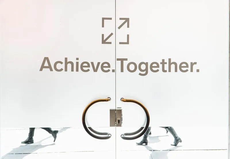 A door with achieve together written in gold