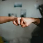 two fists in a fist pump advocacy