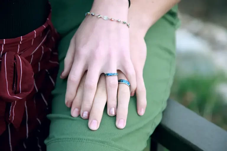 2 hands wearing wedding rings showing status