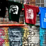 street art depicting a black man on a wall with a line of washing hanging above it