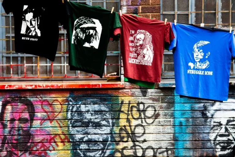 street art depicting a black man on a wall with a line of washing hanging above it