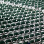 Rows and rows and identitcal seats representing assimilation