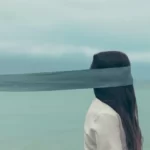 an artistic shot of a woman with a blindfold on which extends backwards out of shot. avoidance relationships