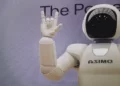 A white robot doing devil horns - automation