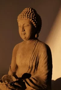 A statue of the buddha in shades of brown