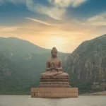 A statue of the buddha atop a mountain