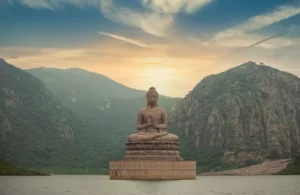 A statue of the buddha atop a mountain