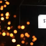 night shot of a light box sign saying 'standards'