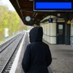 A working class boy at the train station