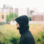 A working class man with his hood up