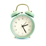 green alarm clock against a white background