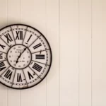 A wall clock in the roman numeral style
