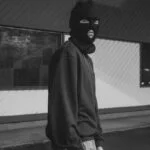 a man wearing a balaclava being a bad actor