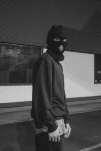 a man wearing a balaclava being a bad actor