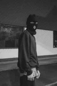 a man wearing a balaclava being a bad actor