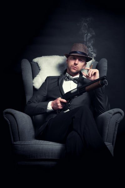 A corporate crime gangster in the back of car with a cigar