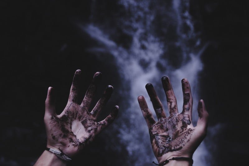 A pair of hands covered in industrial dirt