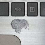 a fingerprint on a laptop - crime deviance