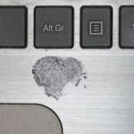 a fingerprint on a laptop - crime deviance