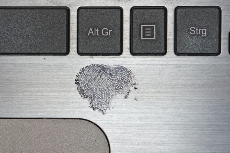 a fingerprint on a laptop - crime deviance
