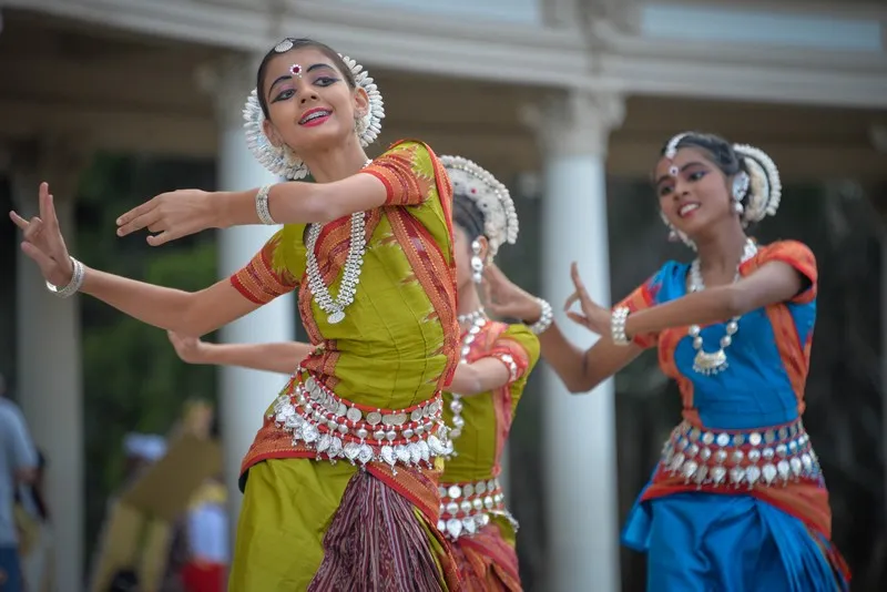 A group of indian women peforming a traditional indian dance