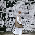 A muslim man walking past street art culture