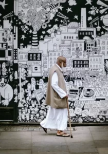 A muslim man walking past street art culture