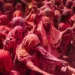Women covered in red paint at a cultural festival