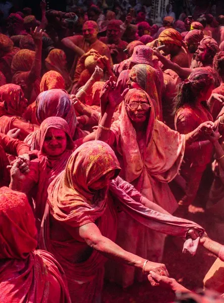 Women covered in red paint at a cultural festival