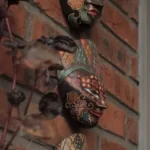 Three cultural masks on a wall