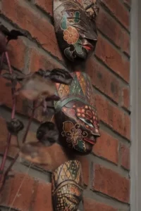 Three cultural masks on a wall
