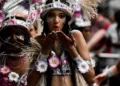 A woman in cultural dress blowing a kiss